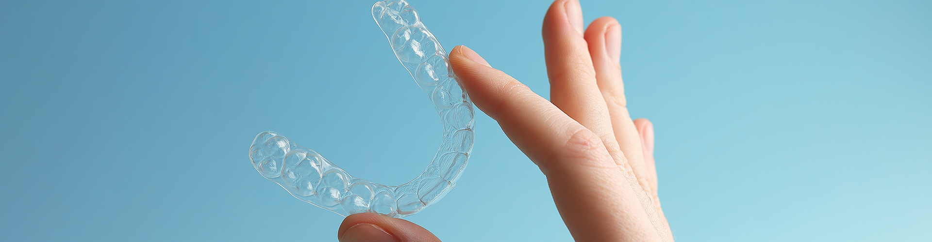 hand holding clear aligner